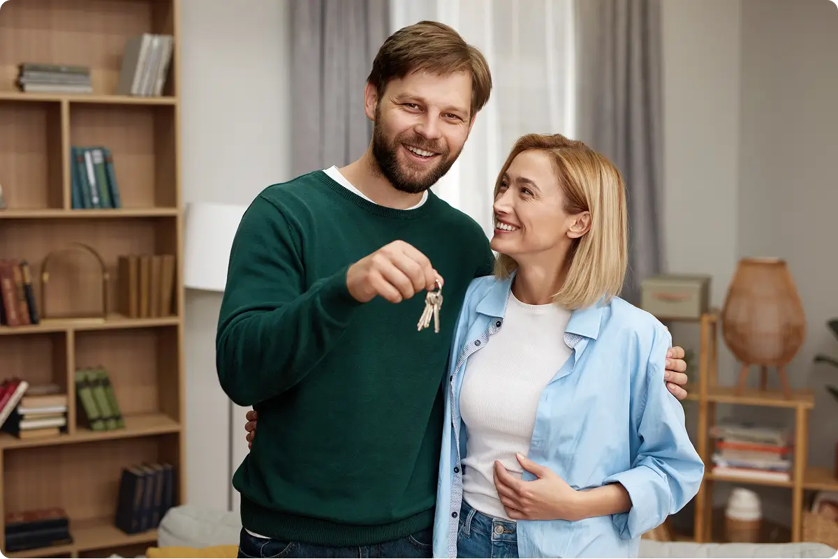 Happy couple holding keys